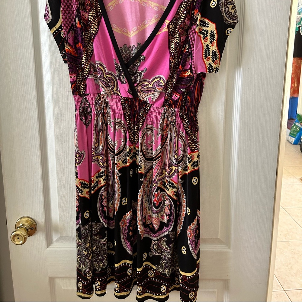 Mini dress with vibrant pink colors and design.
